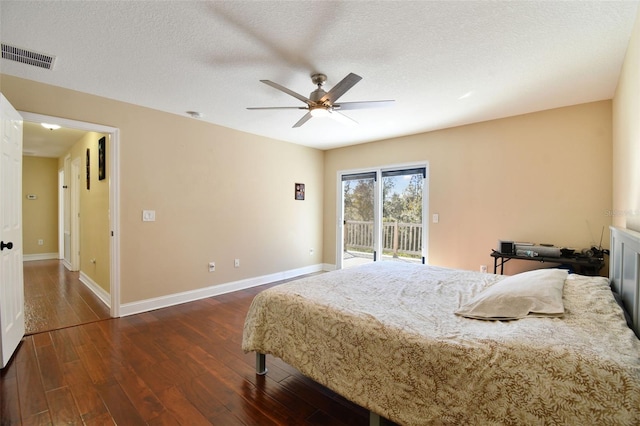 bedroom with a textured ceiling, access to exterior, ceiling fan, and dark hardwood / wood-style floors