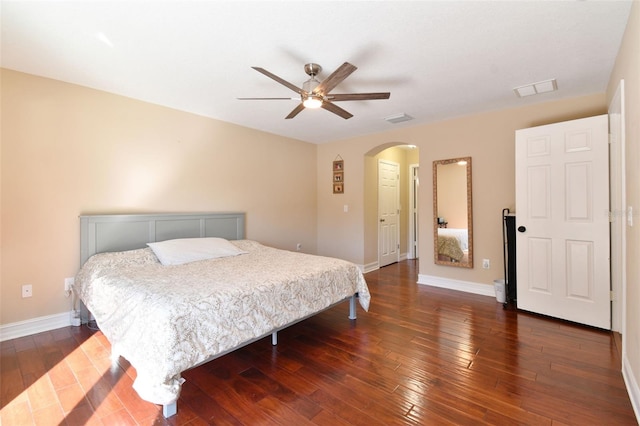 bedroom with dark hardwood / wood-style flooring and ceiling fan