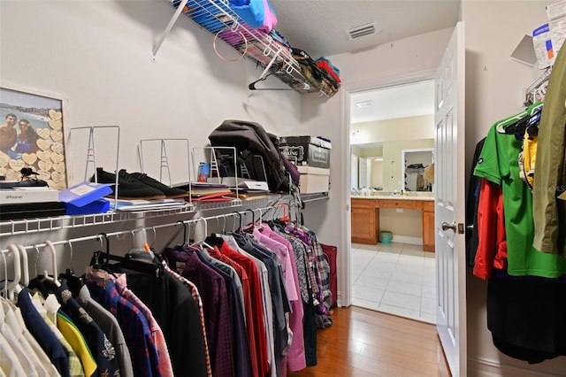 spacious closet with hardwood / wood-style floors