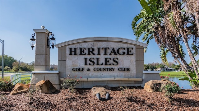 community / neighborhood sign with a water view