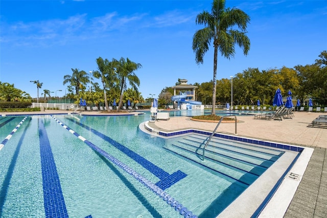 view of swimming pool featuring a patio area and a water slide