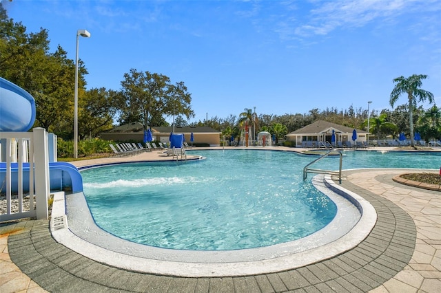 view of pool with a patio area and pool water feature