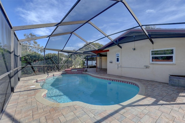 view of pool featuring an in ground hot tub, a lanai, and a patio area