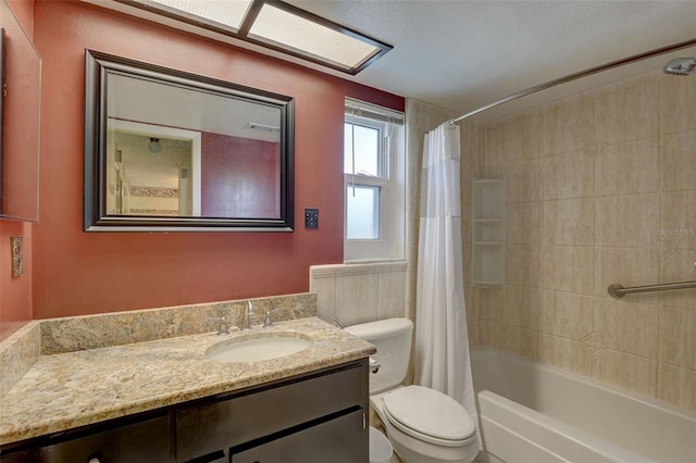 full bathroom with vanity, shower / tub combo, and toilet