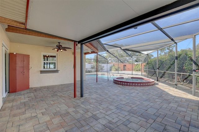 view of patio / terrace with glass enclosure, a pool with hot tub, and ceiling fan