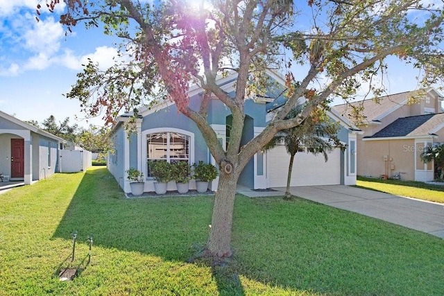 view of front facade with a garage and a front lawn