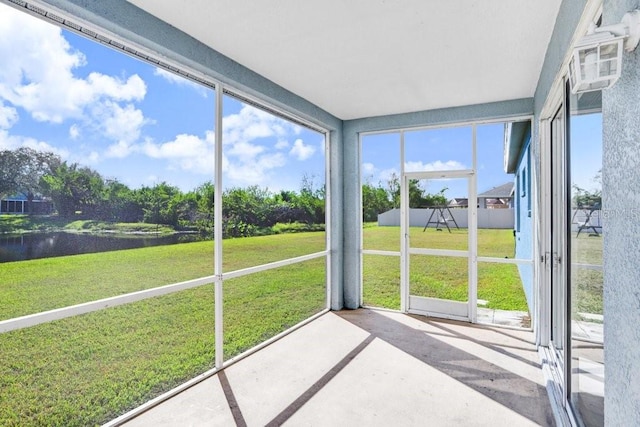 unfurnished sunroom with a water view