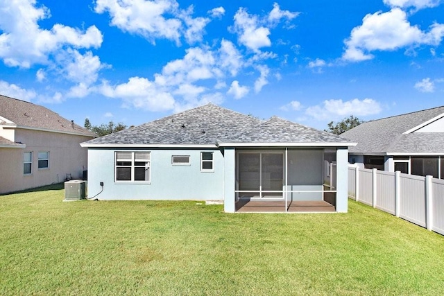 rear view of property with a lawn, a sunroom, and central air condition unit