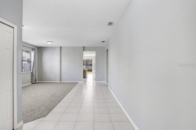 corridor featuring light colored carpet