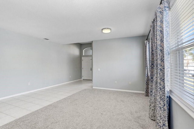 spare room featuring light tile patterned floors