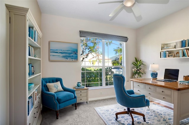 office featuring a healthy amount of sunlight, light colored carpet, and ceiling fan