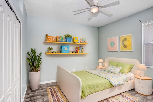 bedroom with hardwood / wood-style flooring, a closet, and ceiling fan