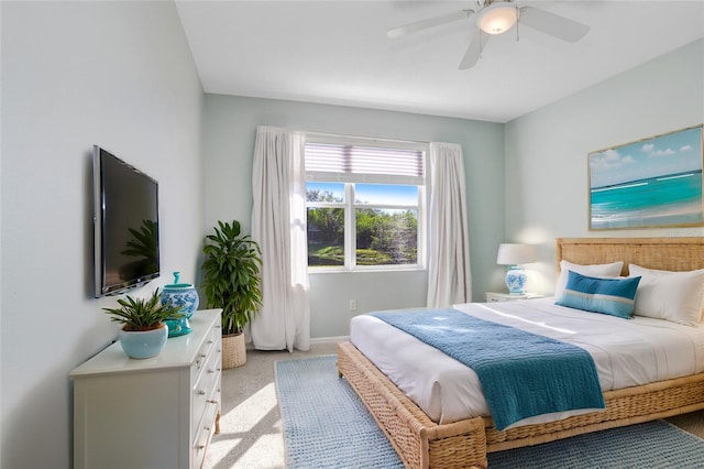 bedroom with ceiling fan and light colored carpet