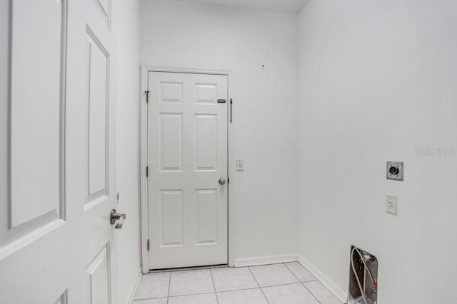 washroom with electric dryer hookup and light tile patterned floors