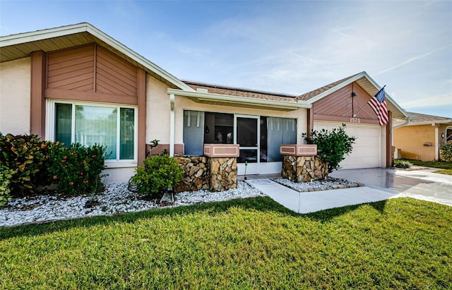 ranch-style house with a front yard and a garage