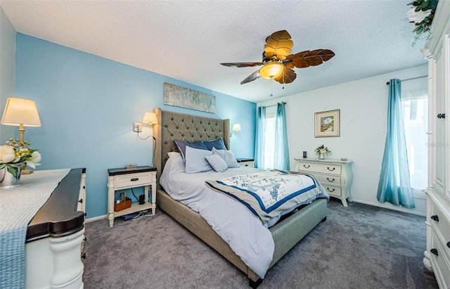 carpeted bedroom with a ceiling fan, multiple windows, a textured ceiling, and baseboards