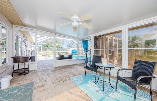 sunroom featuring ceiling fan