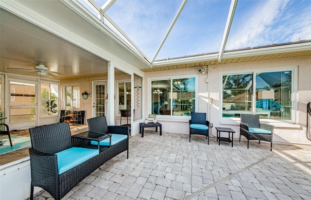 view of patio featuring glass enclosure and ceiling fan