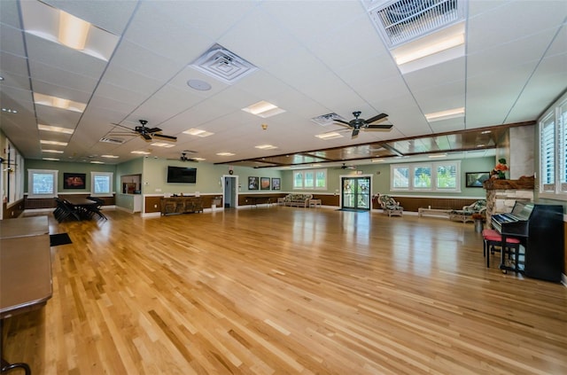 interior space with a paneled ceiling, visible vents, and light wood-style flooring