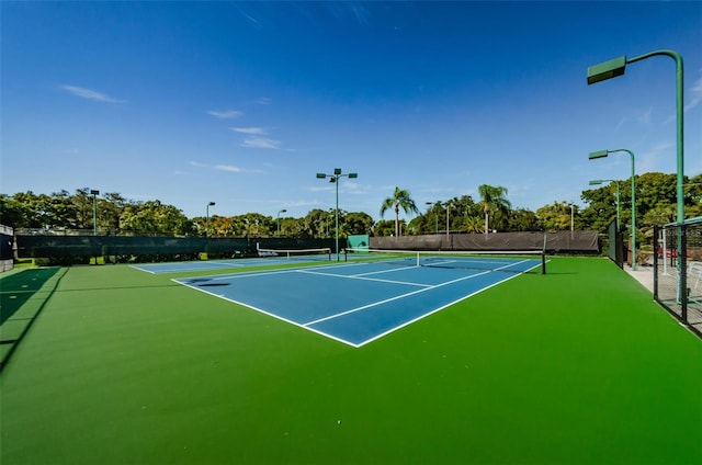 view of tennis court with fence