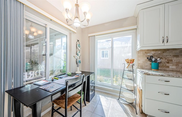 dining room with light tile patterned flooring and an inviting chandelier