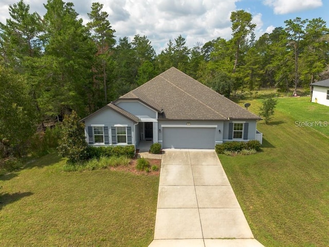 single story home featuring a garage and a front lawn