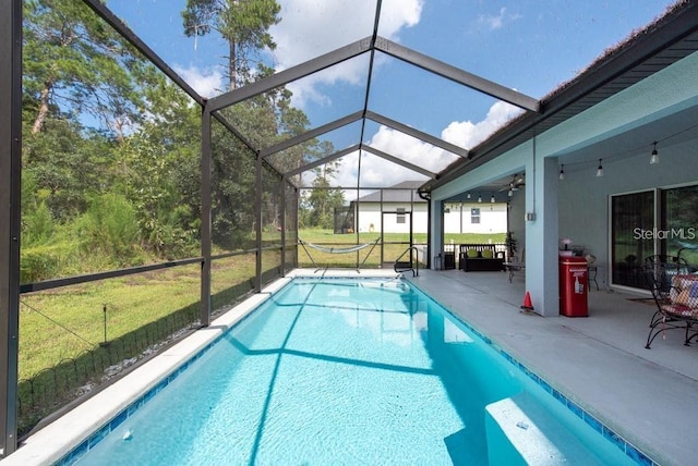 view of pool with a yard, ceiling fan, and a patio area