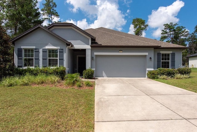 view of front of house with a front yard and a garage