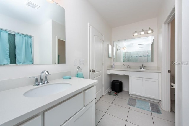 bathroom featuring tile patterned floors, a shower, and vanity