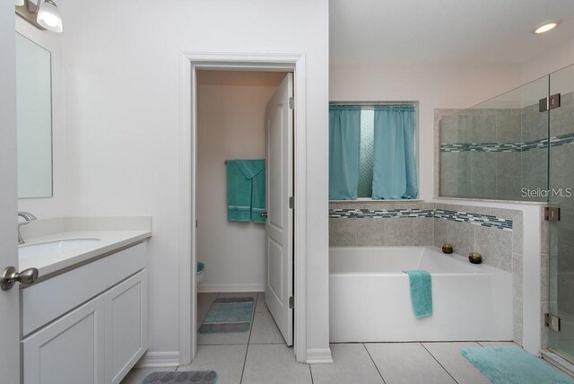 full bathroom with plus walk in shower, tile patterned flooring, vanity, and toilet