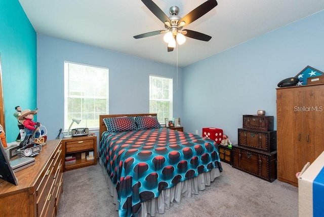 bedroom with ceiling fan and light colored carpet