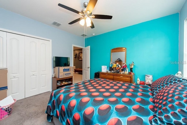 carpeted bedroom featuring ceiling fan and a closet