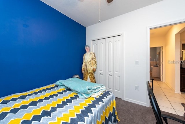 carpeted bedroom with ceiling fan and a closet