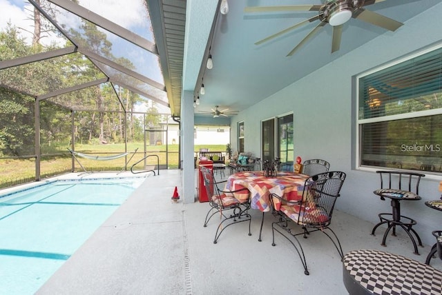 view of patio / terrace featuring ceiling fan and glass enclosure