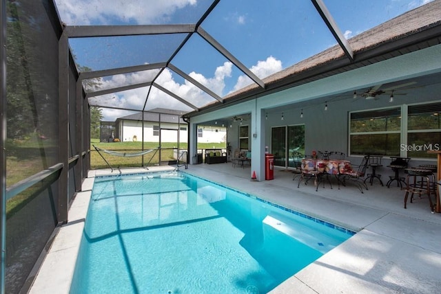 view of pool with a patio area, ceiling fan, and a lanai