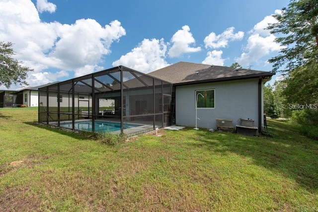 back of property featuring a yard and glass enclosure