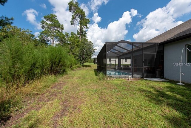 view of yard featuring a lanai