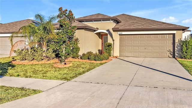 view of front of property with a front lawn and a garage