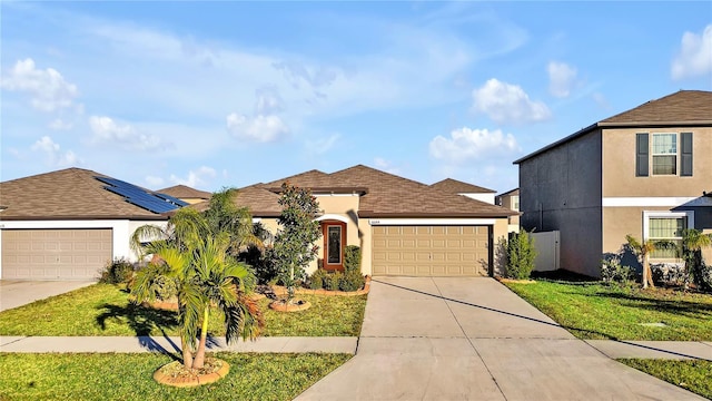 view of front of house featuring a front yard and a garage