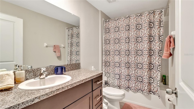 full bathroom with shower / bath combo with shower curtain, vanity, and toilet