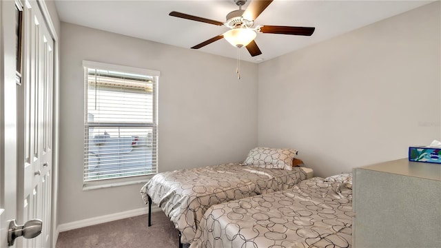 carpeted bedroom with a closet and ceiling fan