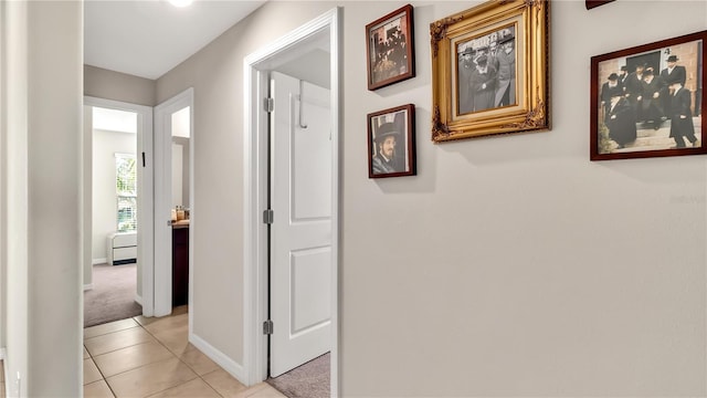 hall with light colored carpet