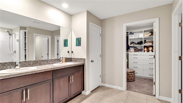 bathroom featuring tile patterned floors, vanity, and walk in shower