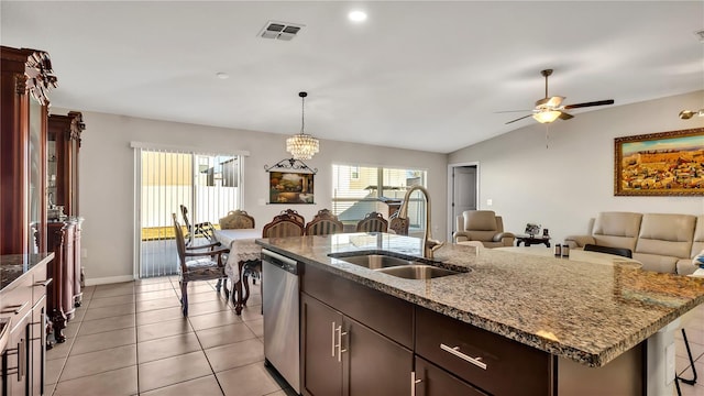 kitchen with dishwasher, a center island with sink, ceiling fan with notable chandelier, sink, and vaulted ceiling