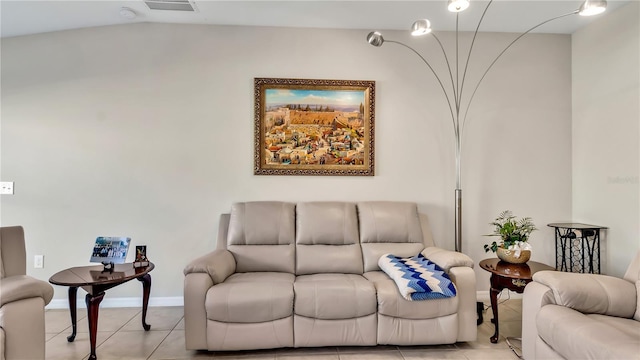 living room with light tile patterned floors and vaulted ceiling