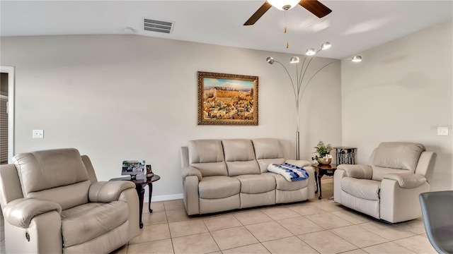 living room featuring ceiling fan, light tile patterned flooring, and lofted ceiling