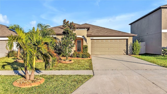 view of front of home featuring a front yard and a garage