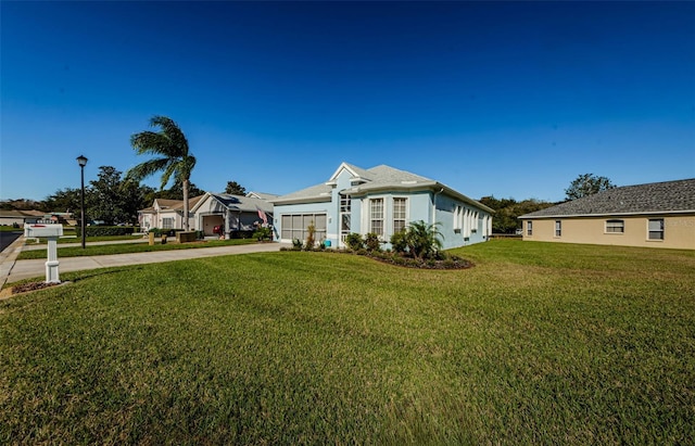 ranch-style home with a front yard and a garage