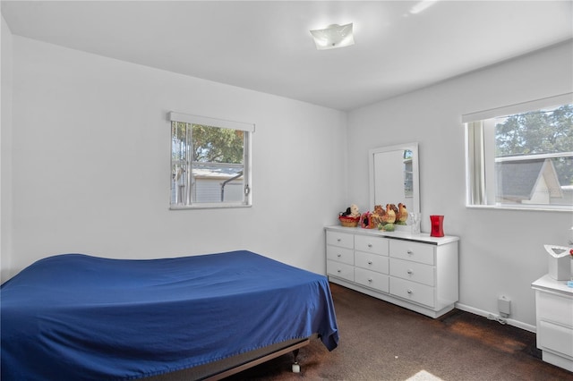 bedroom with dark colored carpet