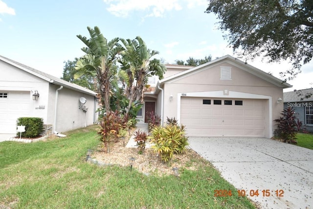 504 Maple Pointe Dr, Seffner, FL 33584 - single story home featuring stucco siding, driveway, an attached garage, and a front lawn